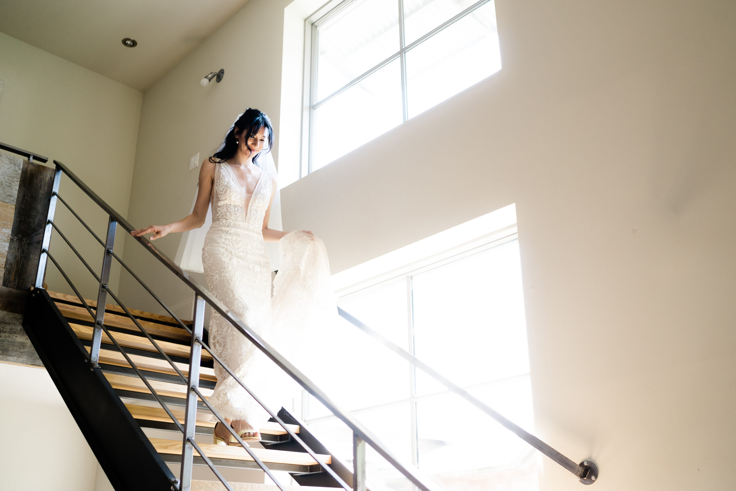 Bride walking down stairs at Compass Rose Weddings