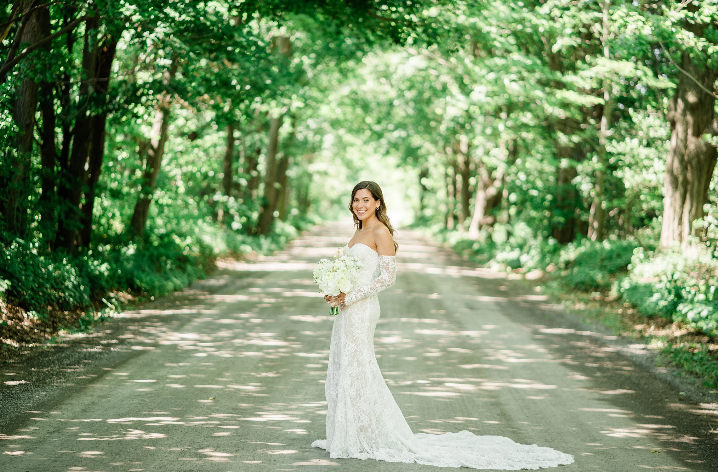 Full-length bridal portrait on the lane at Compass Rose Suites in Prince Edward County.
