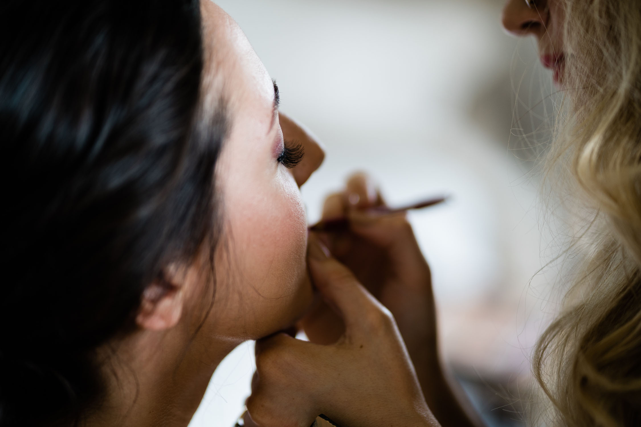 Bride having her makeup done by a professional.