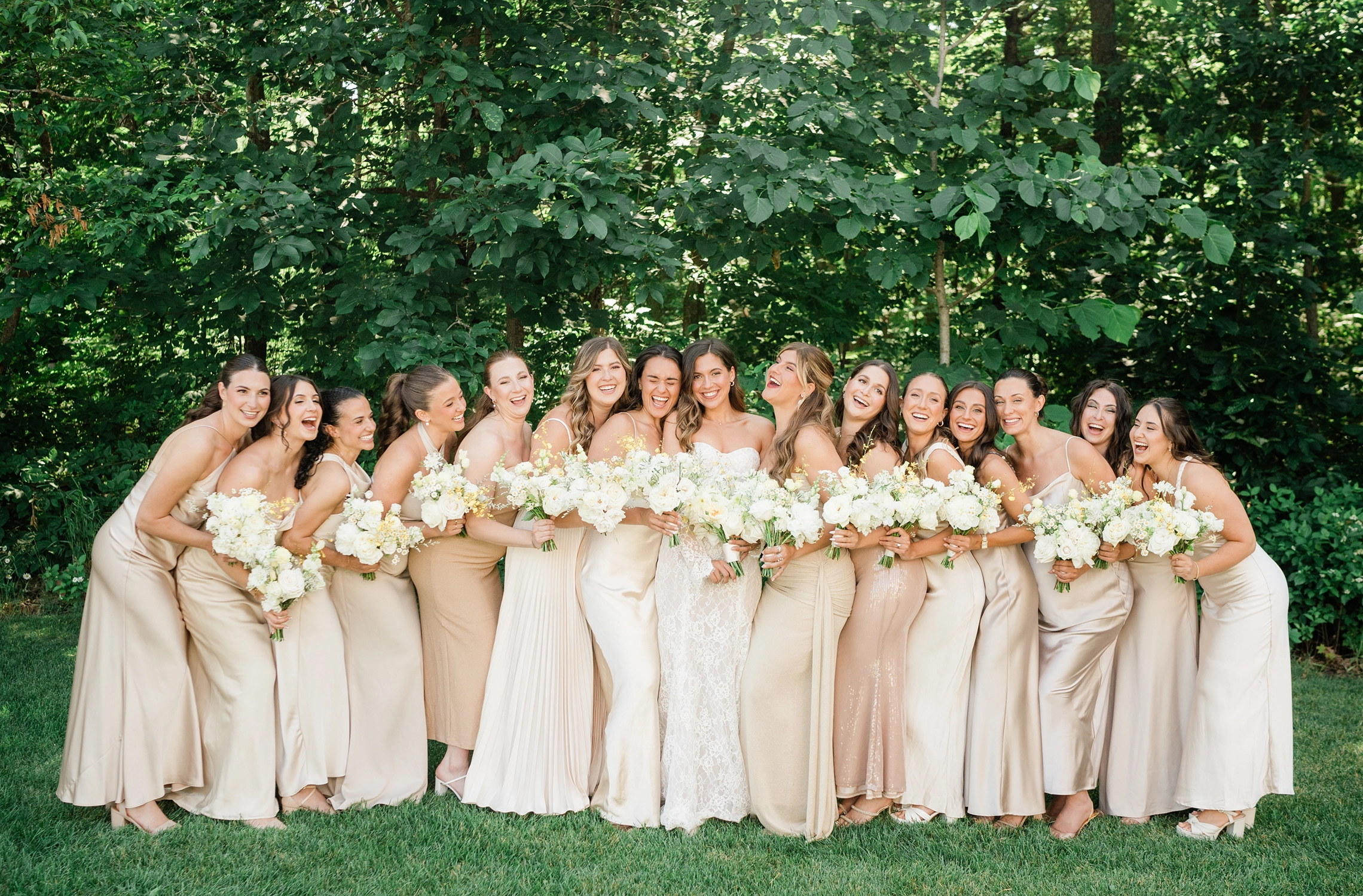 Bridesmaids hugging the bride at Compass Rose Suites in Prince Edward County.