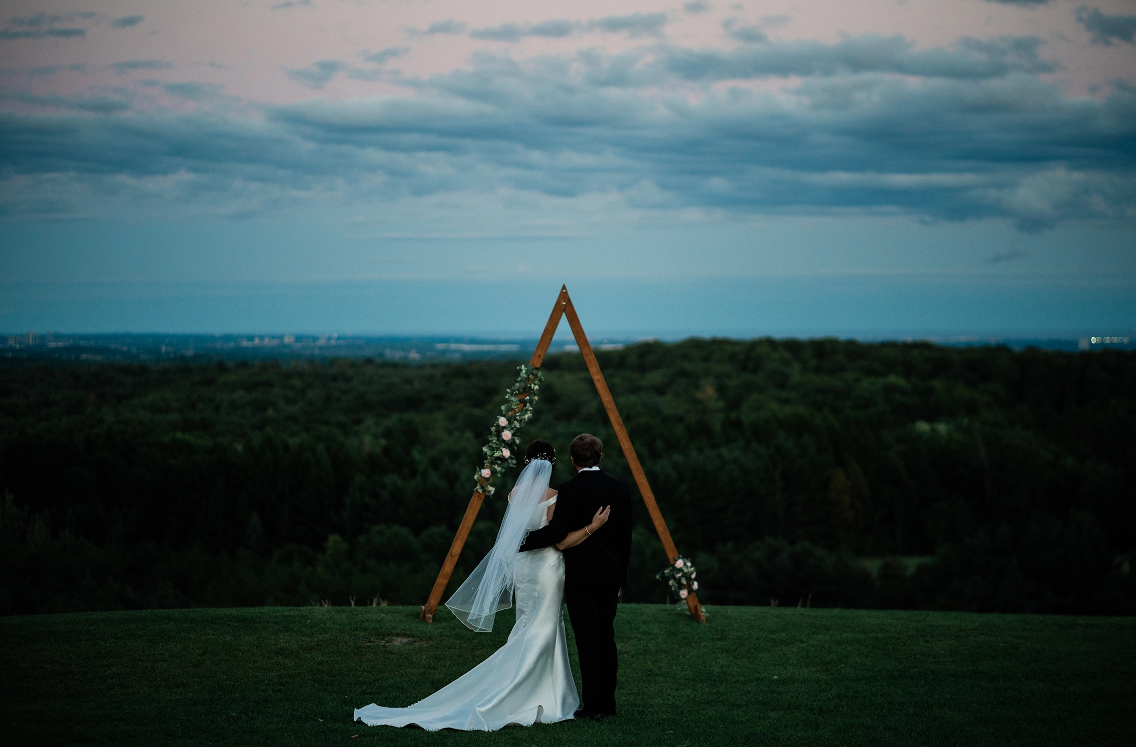 Couple at dusk under the A-frame arch at Trail Hub in Ajax Ontario