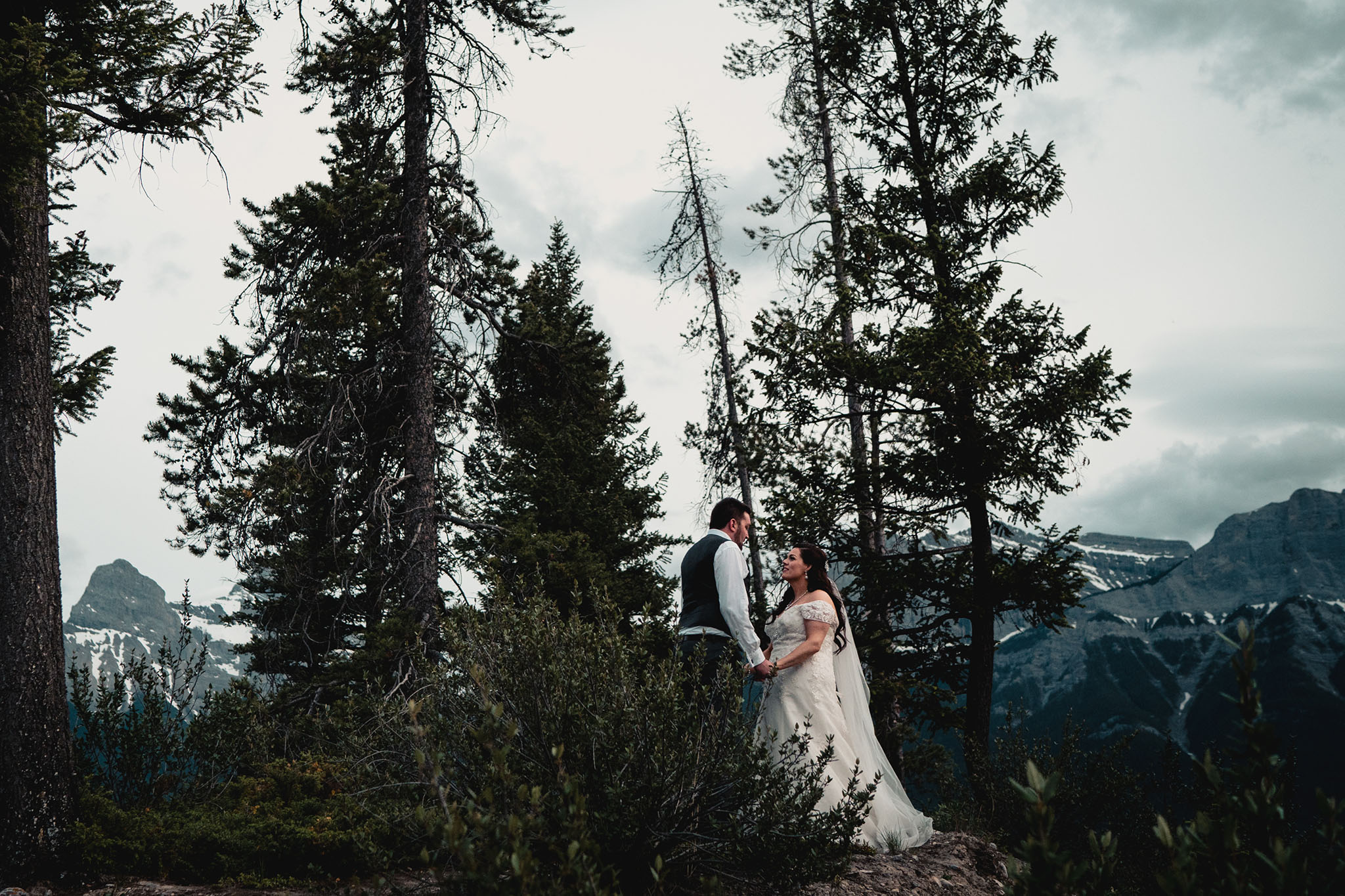Gorgeous couple with the Rocky Mountains behind them as a backdrop.